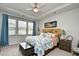 Bright bedroom featuring a ceiling fan and a large window for ample natural light at 234 Rolling Woods Ct., Little River, SC 29566