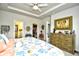 Cozy bedroom showcases a dresser, walk-in closet, and adjacent bathroom at 234 Rolling Woods Ct., Little River, SC 29566