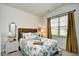 Cozy bedroom featuring a coastal themed bed, a window, and tasteful decor at 234 Rolling Woods Ct., Little River, SC 29566