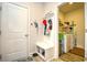 Entryway with bench and storage leads to laundry room with washer and dryer at 234 Rolling Woods Ct., Little River, SC 29566