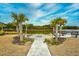 Serene waterfront fire pit area with palm trees and scenic views, ideal for gatherings at 234 Rolling Woods Ct., Little River, SC 29566
