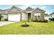 Charming home with stone accents, a well-manicured lawn, and a freshly planted palm tree at 234 Rolling Woods Ct., Little River, SC 29566
