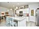 Well-lit kitchen with breakfast bar, stainless steel appliances, and white cabinets at 234 Rolling Woods Ct., Little River, SC 29566
