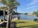 Picturesque lake view featuring a charming pier and waterfront homes in the distance at 234 Rolling Woods Ct., Little River, SC 29566
