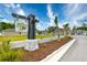 Street view of Hidden Brooke community entrance sign with palm trees and tidy landscaping at 234 Rolling Woods Ct., Little River, SC 29566