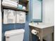 Clean bathroom with a toilet, a sink with towels, toiletries, and an accent wall at 2401 S Ocean Blvd. # 557, Myrtle Beach, SC 29577