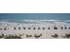 Panoramic beach view showcasing sand, umbrellas, ocean waves, and a clear blue sky for an idyllic coastal experience at 2401 S Ocean Blvd. # 557, Myrtle Beach, SC 29577