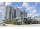 Luxury condominium building with palm trees and a view of the ocean at 2401 S Ocean Blvd. # 557, Myrtle Beach, SC 29577
