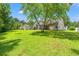 Expansive backyard with lush green grass and mature trees, ideal for outdoor activities at 2487 Windmill Way, Myrtle Beach, SC 29579