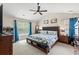 Spacious primary bedroom with a ceiling fan and plenty of natural light from large window at 2487 Windmill Way, Myrtle Beach, SC 29579