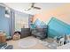 Colorful Bedroom with custom wall art, a gray crib, dresser and decorative alphabet rug at 2487 Windmill Way, Myrtle Beach, SC 29579