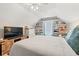 Attic bedroom features sloped ceilings, a comfy bed, modern television, and built-in shelves at 2487 Windmill Way, Myrtle Beach, SC 29579
