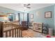 Bright Bedroom features fun celestial decor, a rocking chair, changing table, and a crib at 2487 Windmill Way, Myrtle Beach, SC 29579