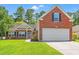 Charming brick and vinyl home featuring an attached garage and well-maintained lawn at 2487 Windmill Way, Myrtle Beach, SC 29579
