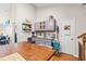 Bright kitchen with gray cabinets, granite countertops, and floating shelves for storage at 2487 Windmill Way, Myrtle Beach, SC 29579