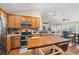 Open kitchen features stainless steel appliances, wood cabinets, and large central island at 2487 Windmill Way, Myrtle Beach, SC 29579