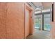 Hallway leading to an elevator, with a glimpse of the indoor pool at 2710 S Ocean Blvd. # 402, Myrtle Beach, SC 29577