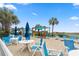 Inviting beach area with colorful bar, tables, umbrellas, and chairs for residents and guests to enjoy at 300 N Ocean Blvd. # 122, North Myrtle Beach, SC 29582