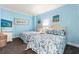 Bright bedroom featuring two cozy beds with matching bedding, wall art, and blue walls at 300 N Ocean Blvd. # 122, North Myrtle Beach, SC 29582