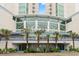 Exterior of the Avista Resort with a beautifully landscaped entrance with palm trees, plants, and blue-and-white decor at 300 N Ocean Blvd. # 122, North Myrtle Beach, SC 29582