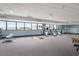Bright gym featuring exercise equipment, mats, and scenic views from large windows at 300 N Ocean Blvd. # 122, North Myrtle Beach, SC 29582