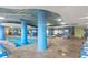 Bright indoor pool area with blue pillars, tiled floors, and chairs for a refreshing swim year-round at 300 N Ocean Blvd. # 122, North Myrtle Beach, SC 29582
