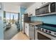 Bright kitchen area with stainless steel appliances and an open floor plan leading to the balcony at 300 N Ocean Blvd. # 122, North Myrtle Beach, SC 29582