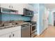 Functional kitchen with stainless steel appliances, granite counters, and white cabinetry, designed for convenience at 300 N Ocean Blvd. # 122, North Myrtle Beach, SC 29582