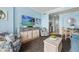 Coastal living area featuring a TV, comfortable seating, and stylish decor, creating a welcoming ambiance at 300 N Ocean Blvd. # 122, North Myrtle Beach, SC 29582