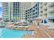 Stunning exterior view of the pool, tanning chairs, and manicured grounds for luxurious outdoor living at 300 N Ocean Blvd. # 122, North Myrtle Beach, SC 29582