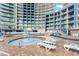 Resort pool featuring multiple lounge chairs, a mushroom fountain, and a large resort in the background at 300 N Ocean Blvd. # 122, North Myrtle Beach, SC 29582