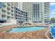 Large outdoor pool surrounded by lounge chairs, set against the backdrop of a modern resort at 300 N Ocean Blvd. # 122, North Myrtle Beach, SC 29582
