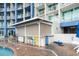 Poolside bar featuring colorful chairs, retractable awning and a wet brick floor at 300 N Ocean Blvd. # 122, North Myrtle Beach, SC 29582