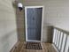 This is an eye-level shot of a front door with a welcome mat, with outdoor light at 300-J Myrtle Greens Dr. # J, Conway, SC 29526