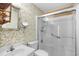 Updated bathroom featuring floral wallpaper, vanity, toilet, and glass-enclosed shower at 308 76Th Ave. N # 5, Myrtle Beach, SC 29572