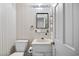 This bathroom features a toilet, vanity, mirror, and storage basket at 308 76Th Ave. N # 5, Myrtle Beach, SC 29572