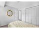 Bright bedroom featuring neutral walls, carpet, and closet with bi-fold doors plus a gold-framed mirror at 308 76Th Ave. N # 5, Myrtle Beach, SC 29572