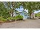 Charming two-story home features well-maintained landscaping, a private parking area, and mature trees at 308 76Th Ave. N # 5, Myrtle Beach, SC 29572