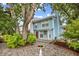 Charming two-story home with a bird bath surrounded by well-maintained landscaping and mature trees at 308 76Th Ave. N # 5, Myrtle Beach, SC 29572