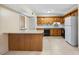 Eat-in kitchen featuring wood cabinets, built-in desk and tile flooring at 308 76Th Ave. N # 5, Myrtle Beach, SC 29572