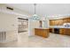 Eat-in kitchen featuring tile flooring, wood cabinets, and peninsula seating at 308 76Th Ave. N # 5, Myrtle Beach, SC 29572
