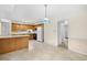 Eat-in kitchen boasts wood cabinets, tile flooring, and modern appliances at 308 76Th Ave. N # 5, Myrtle Beach, SC 29572