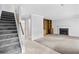 Living room featuring a fireplace, staircase, and built-in wooden shelving unit at 308 76Th Ave. N # 5, Myrtle Beach, SC 29572