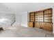 Cozy living room with carpet, adjacent to a staircase, and features a built-in wooden bookshelf at 308 76Th Ave. N # 5, Myrtle Beach, SC 29572