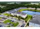 Aerial view of apartment buildings featuring a pond, parking, and landscaping at 340 Kiskadee Loop, Conway, SC 29526