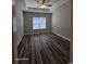 Bedroom with tray ceiling, wood-look flooring, and window to allow natural light at 340 Kiskadee Loop, Conway, SC 29526