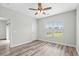 Comfortable bedroom featuring a ceiling fan, wood-look floors, a window, and neutral paint at 340 Kiskadee Loop, Conway, SC 29526