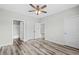 Bright bedroom with wood-look floors, neutral paint, a ceiling fan, and an attached bathroom at 340 Kiskadee Loop, Conway, SC 29526