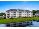 Exterior view showcasing the building's architecture reflected in the serene pond at 340 Kiskadee Loop, Conway, SC 29526