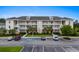 A well maintained three-story condo building with ample parking and landscaping at 340 Kiskadee Loop, Conway, SC 29526